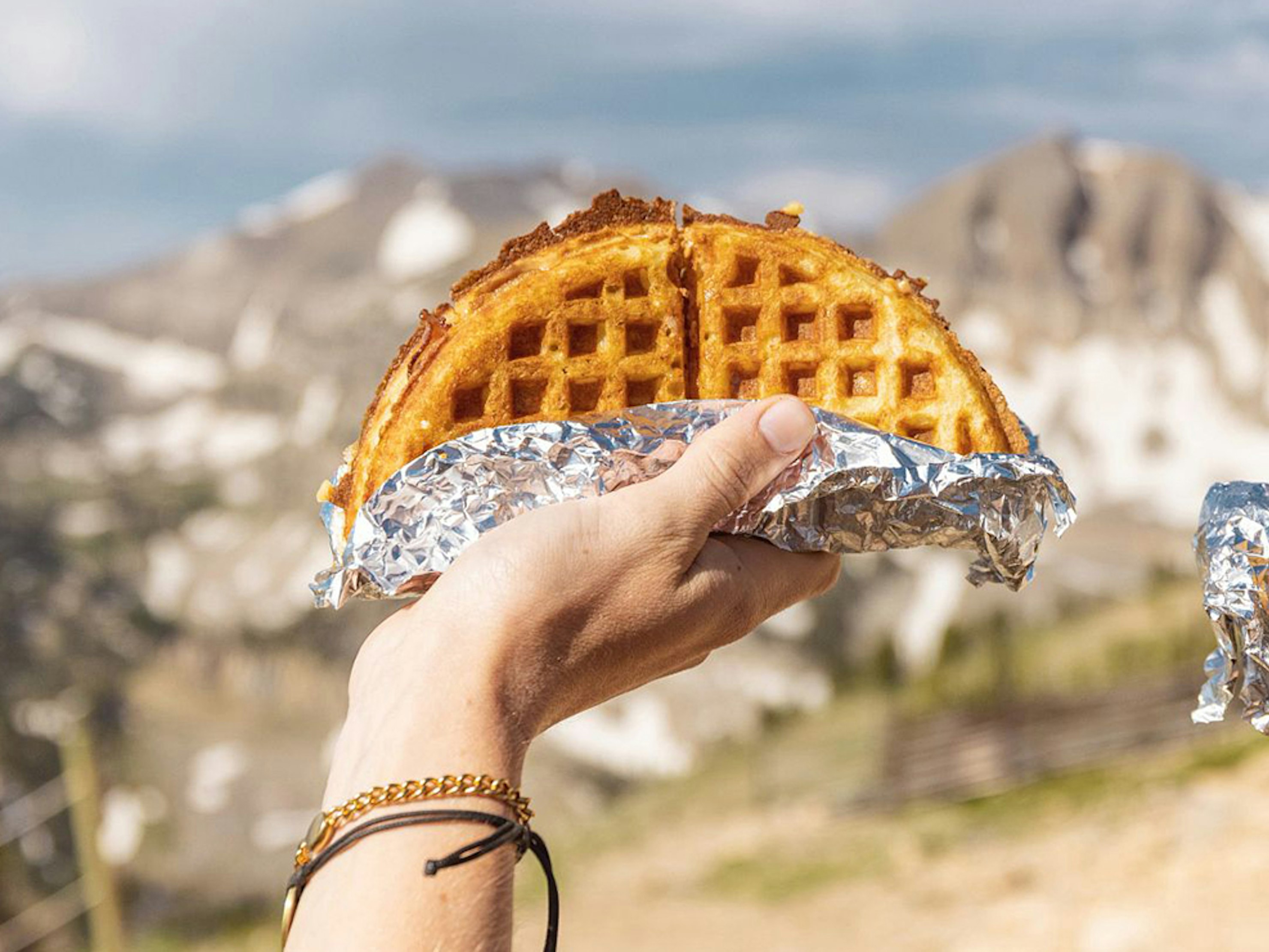 Holding waffles up outside Corbet's Cabin